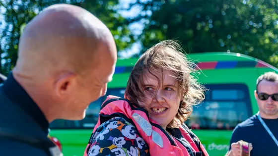 young lady smiling at man wearing a life jacket