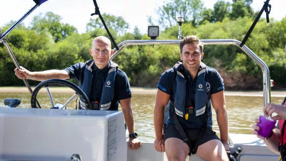 teachers smiling on the back of a boat