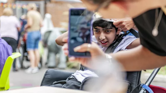 student smiling whilst having their photo taken