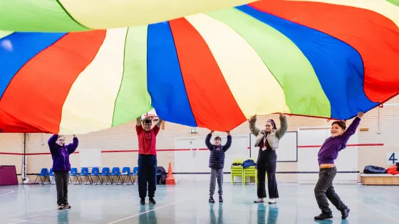 A group of St Piers students lift a parachute.