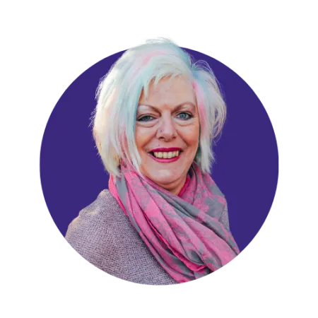 Short blonde haired woman with pink streaks smiling