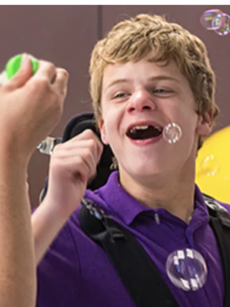 Student and teacher blow bubbles